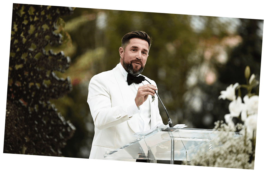 Aaron speaking at an event from a podium.